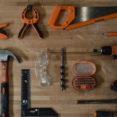 A variety of carpentry tools arranged neatly on a wooden surface, ideal for DIY projects.